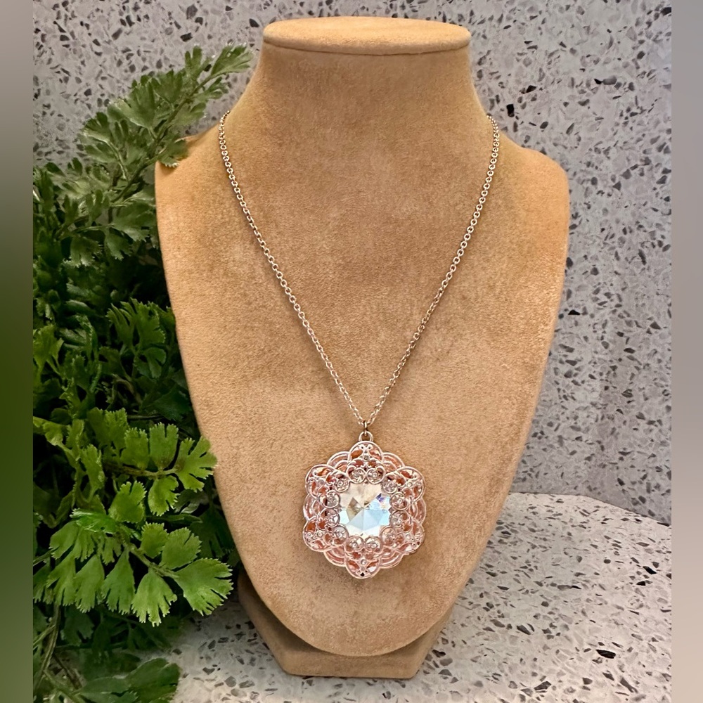Copper tone filigree pendant with crystal center